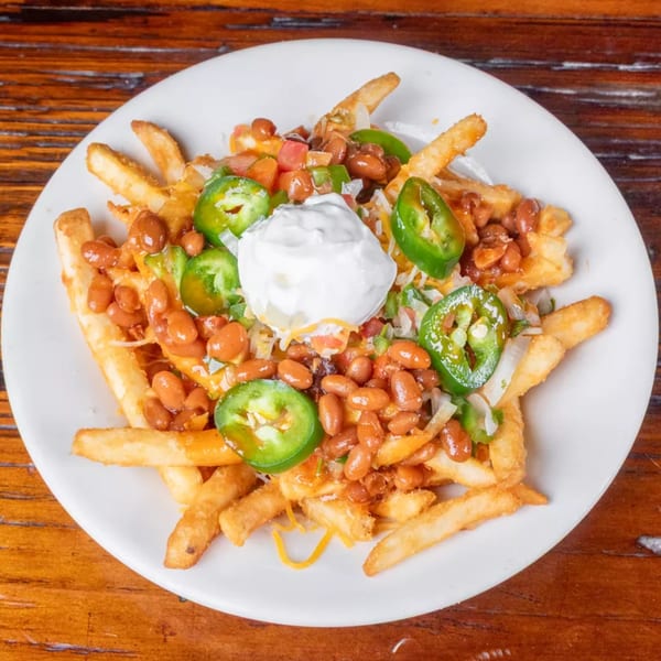 Chili cheese fries topped with pinto beans, jalapeños, diced tomatoes, and a dollop of sour cream.